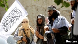 Taliban fighters celebrate a cease-fire in the Ghanikhel district of Nangarhar Province on June 16.