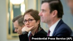 Then U.S. Ambassador to Ukraine Marie Yovanovitch, center, sits during her meeting with Ukrainian President Petro Poroshenko in Kyiv, March 6, 2019
