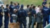 Asylum seekers wait to board a bus near the Hungarian-Serbian border last year. (file photo)