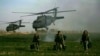 FILE: U.S. army special forces walk in a field as Blackhawk helicopters transporting NATO officers land in Marjah's Balakino Bazar neighborhood in 2010.
