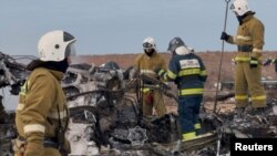 Emergency specialists work at the crash site of a passenger plane near Aktau
