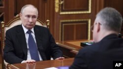Russian President Vladimir Putin meets a Russian regional official at the Kremlin, July 28, 2025.