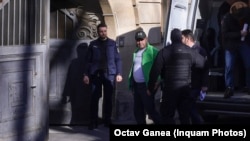 Adrian Robertin Dinu (cu geacă verde) este adus pe 6 martie 2025 la Curtea de Apel București.