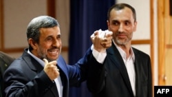 Former Iranian President Mahmud Ahmadinejad (left) stands with former Vice President Hamid Baghaei after registering at the Interior Ministry's election headquarters as candidates for the upcoming presidential election in Tehran on April 12.