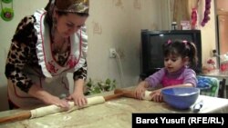 Таджикская бизнес-леди Шахноз Комилзода учит свою дочь Мумтаз готовить манты. Душанбе, 5 марта 2013 года