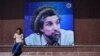Afghanistan -- An Afghan boy sits next to poster bearing the image of the late resistance leader Ahmad Shah Masud as his fourteenth death anniversary is marked in Kabul, September 9, 2015