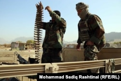 Afghan soldiers prepare to load a machine gun mounted on a truck on the outskirts of the southern Afghan city of Kandahar.