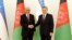 Uzbekistan's President Shavkat Mirziyoev (R) shaking hands with the Afghan President Ashraf Ghani in Tashkent on March 27.