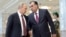 Президент России Владимир Путин (слева) и президент Таджикистана Эмомали Рахмон (справа) во время встречи в Минске. 10 октября 2014 года.