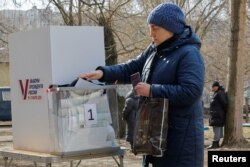 O femeie votează anticipat la o secție de votare mobilă în Donețk, teritoriu ucrainean controlat de Rusia. 10 martie 2024.