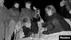 Берлинчани се стичат към стената, след като Шабовски импровизирано заявява, че ограниченията за пътуване отпадат незабавно