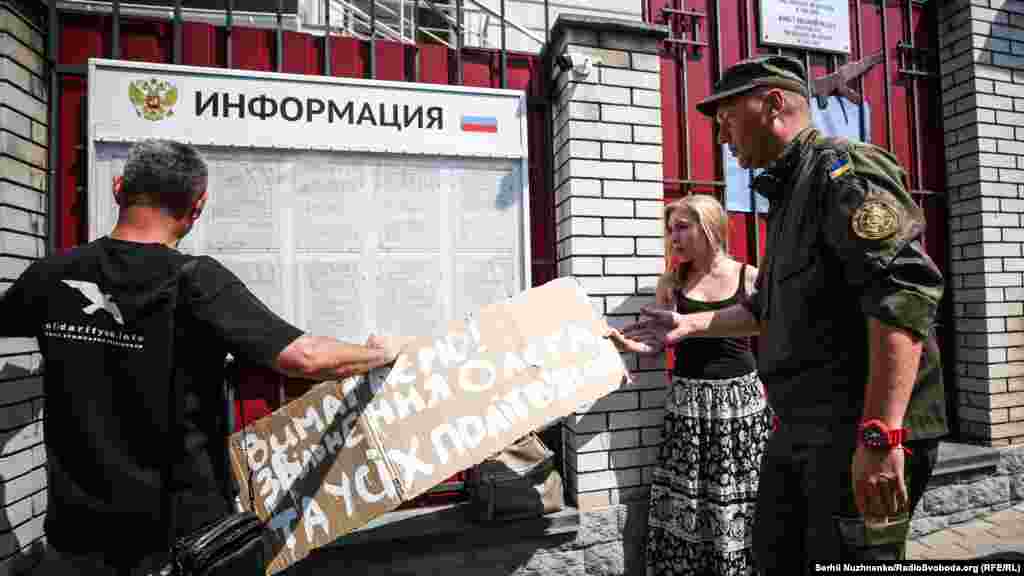 Плакат с основным своим призывом активисты хотели разместить на доске объявлений консульства России в Киеве – охранник не позволил