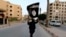 A member of Islamic State militants waves the group's flag in the Syrian city of Raqqa in June.