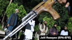 Taliban prisoners stand in a line after their release in the western Afghan city of Herat on June 17.