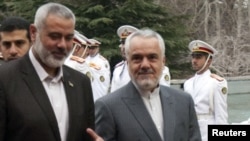 Iran's First Vice President Mohammad Reza Rahimi (right) welcomes Hamas leader Ismail Haniyeh to Tehran on February 10.
