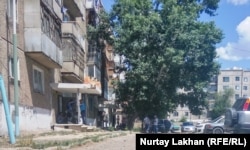 Көпқабатты үйлердің алдында ҰБТ тапсырушыларды күтіп, топталып тұрған адамдар. Аягөз қаласы. 23 маусым 2018 жыл.