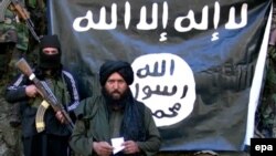 An image made from a video released by the Islamic State (IS) on January 27 purportedly showing Hafiz Said Khan, center, head of IS in Pakistan and Afghanistan, at an undisclosed location along the border.