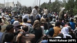 Afganistanci okupljeni na putu u blizini vojnog dijela aerodroma u Kabulu 20. avgusta