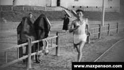 Спортист минава покрай жени с бурки през първите години на съветски Узбекистан.