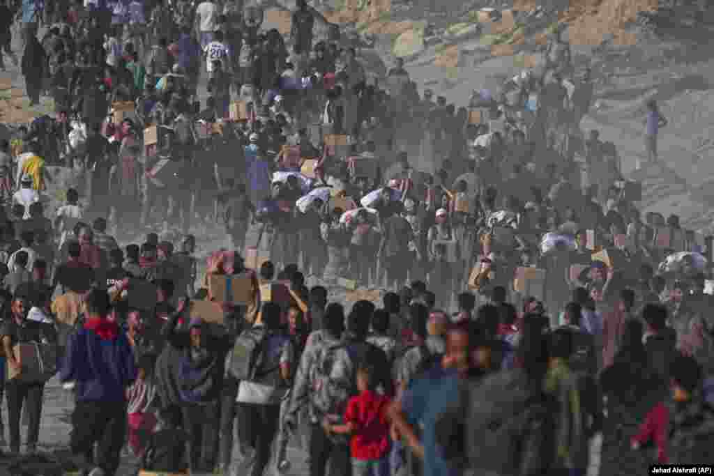 Turma palestinezësh duke bartur ndihmat e pranuara nga Programi Botëror i Ushqimit.