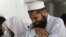 A man cries as he offers funeral prayers with others for the dead Taliban supreme leader Mullah Mohammad in Pakistan on July 31.
