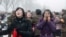 North Korea -- Mourners react as a car Kim Jong-Il's body passes by during the funeral procession in Pyongyang, 28Dec2011