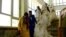 Afghan couples arrive for a mass wedding ceremony in the western city of Herat in May 2017