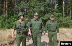 Belarusian President Aleyaksandr Lukashenka (center) visits a military firing range near Hrodno on August 22.