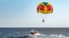 Parasailing colorful parachute motorboat