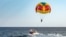 Parasailing colorful parachute motorboat