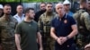 Odesa Mayor Hennadiy Trukhanov (right), standing with President Volodymyr Zelenskyy outside an Odesa apartment building damaged by a Russian missile in 2022
