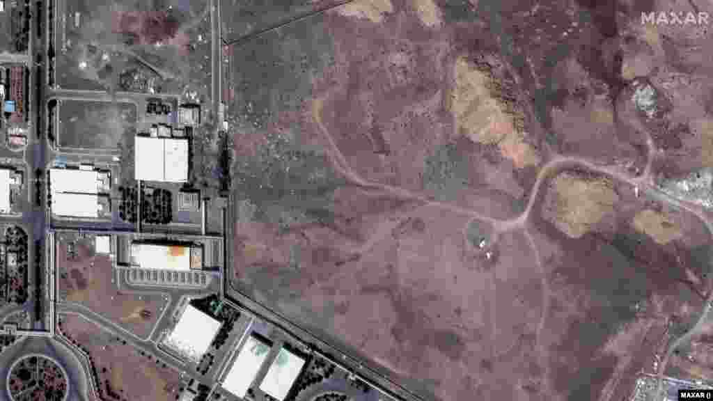 A Maxar satellite image from June 22 shows a crater at Iran's Natanz Enrichment Facility following US air strikes. On June 24, the crater was covered with dirt.