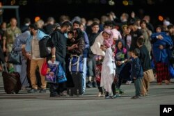 Refugiați din Afganistan sosesc pe aeroportul din Pristina, Kosovo, 29 august 2021.