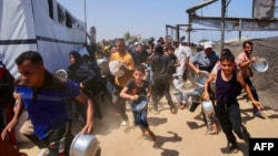 Palestinci žure da stanu u red kako bi dobili hranu, Kan Junis, jug Pojasa Gaze, 22. jula 2025.