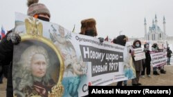 Imagine de la un protest din Kasahstan, din 2021. Vladimir Putin a fost adesea portretizat, ironic, cu imaginea foștilor țari, din cauza mesajelor sale imperialiste, de extindere a teritoriului Rusiei. 