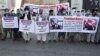Former Afghan interpreters, who worked with U.S. troops in Afghanistan, hold signs during a demonstration about their safety in front of the U.S. Embassy in Kabul on June 25.