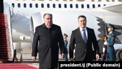Tajik President Emomali Rahmon (left) is welcomed by Kyrgyz President Sadyr Japarov upon his arrival in Bishkek on March 12. 