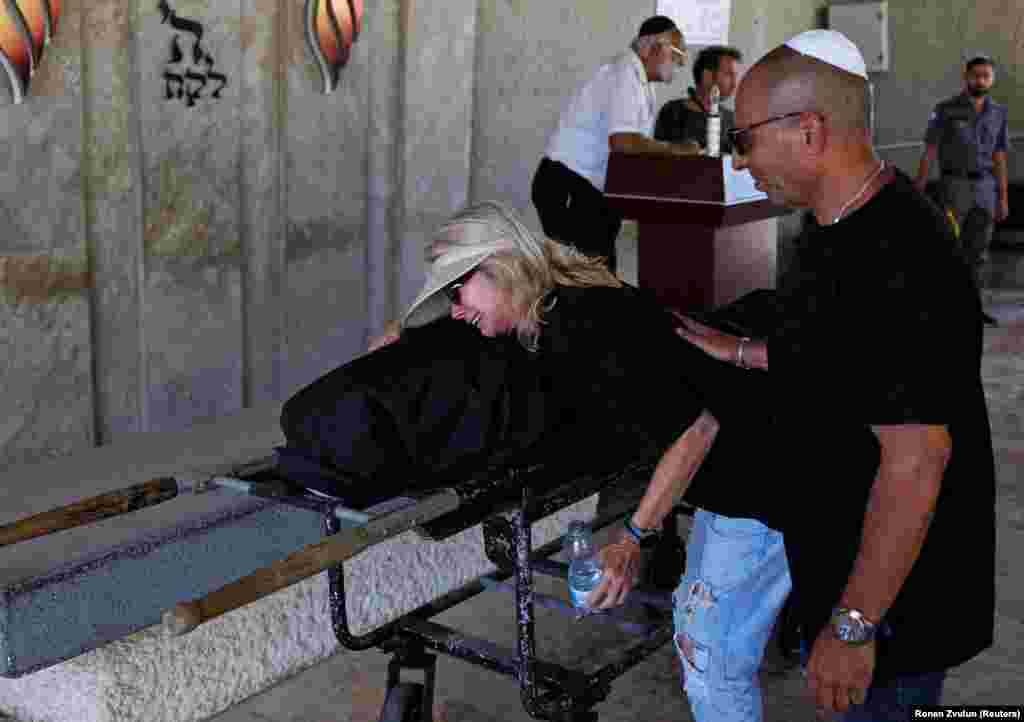 A woman in Holon, Israel, grieves at the funeral of Bella Ashkenazi on June 16. Ashkenazi, 94, was killed when an Iranian missile struck her home on the evening of June 15.