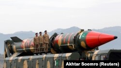 FILE: Pakistani soldiers stand beside a Shaheen III surface-to-surface ballistic missile during a military parade in Islamabad in March 2019.