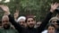 FILE: The leader of Pakistan's Pashtun Tahafuz (Protection) Movement (PTM) Manzoor Pashteen (c) waves to supporters during a demonstration in Lahore in April.