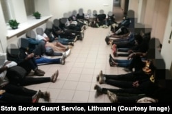 Migrants await processing in Lithuania on July 1.
