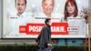 BOSNIA-HERZEGOVINA -- A man walks next to an election campaign poster in Sarajevo, November 10, 2020
