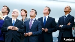 Country leaders watch a fly-past by the Red Arrows during the NATO summit at a resort near Newport, in Wales.