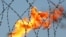 Russia -- gas flame behind razor wire (illustrative); at Rosneft plant in Prirazlomnoye on 22mar2005