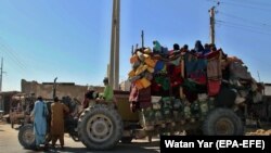 Afghans flee their villages after fighting intensified between Taliban militants and security forces in Lashkar Gah on October 12.