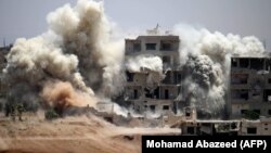 Smoke rises around buildings following a strike on a rebel-held Daraa in June. A cease-fire is due to take effect July 9.