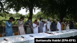 Former Taliban militants surrender their weapons during a reconciliation ceremony in Jalalabad on July 27.