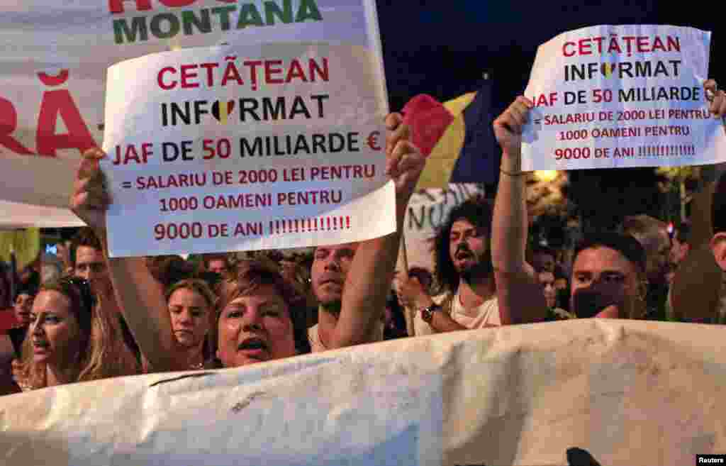 Romania -- Protesters hold banners and shout slogans during a march in front of government headquarters in Bucharest, September 8, 2013