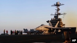 Image taken from video provided by the US Navy shows an aircraft launching from the USS Harry S. Truman in the Red Sea before air strikes in Sanaa, Yemen, on March 15.