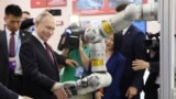 Russian President Vladimir Putin visits an exhibition at the Harbin Institute of Technology in Harbin as part of a 2024 state visit to China. 